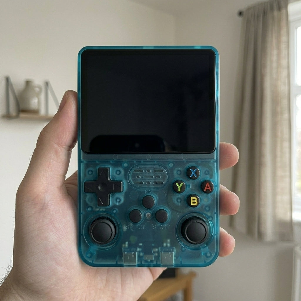 Unit 04, the teal TikTok Shop unit, held in the same hand with a dead black screen